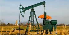 An oil rig in a field.
