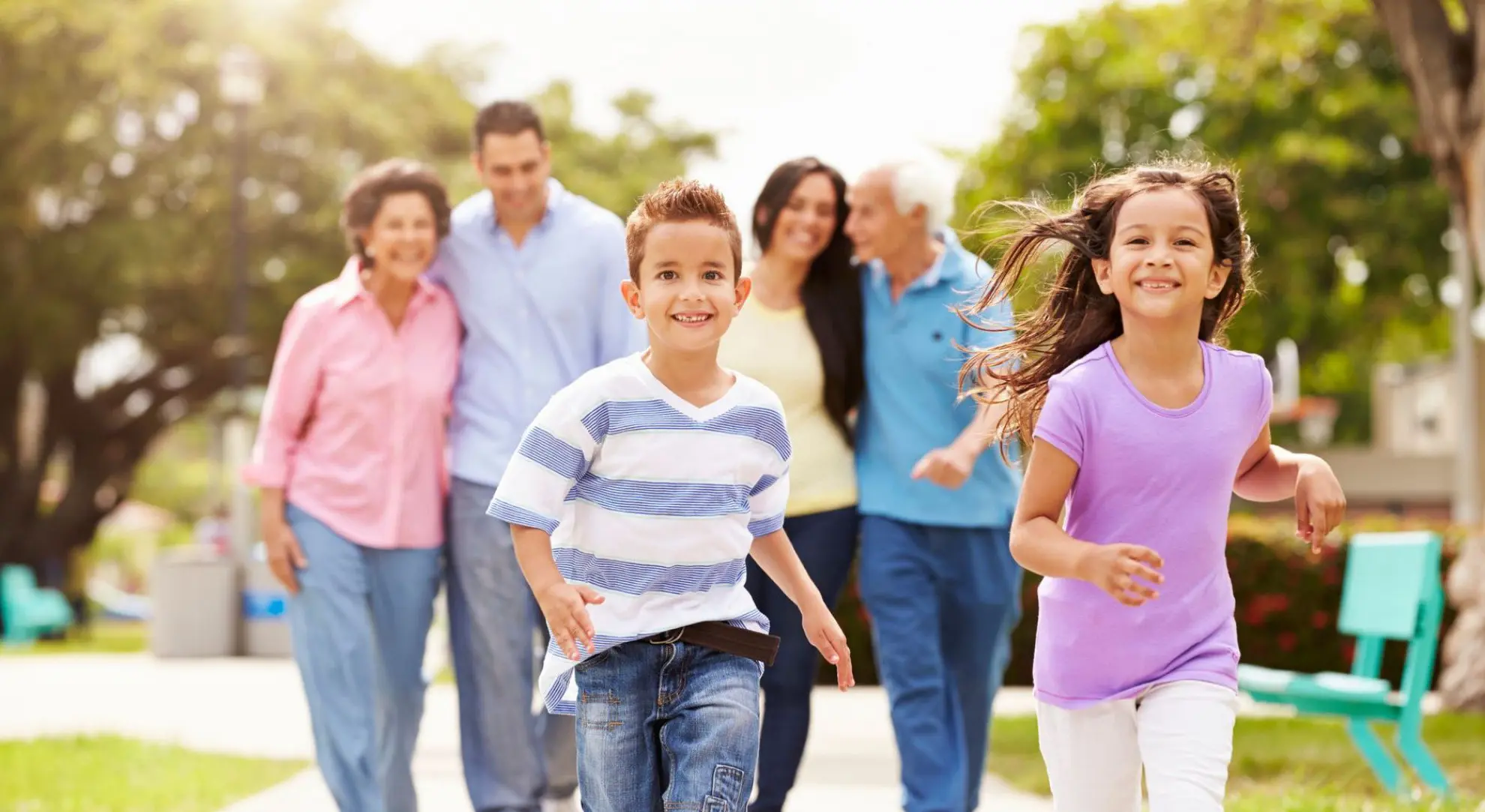 Multi-generation family walking in a park