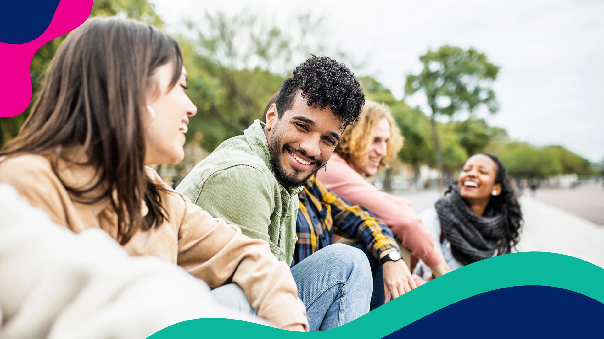 A group of friends smiling while hanging out outdoors